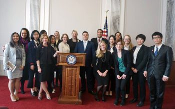 Students from the TPS course in DC gather around a podium